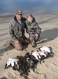 Father son team with their limit of sea ducks